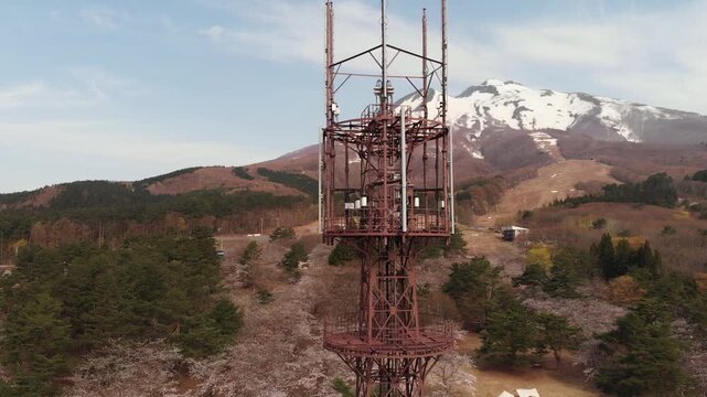 Aerial Drone Over radio tower of Mount Iwaki Japan with rural countryside landscape
