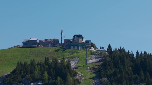 Forte Verena, chairlift station on mountaintop, alpine landscape in summer. Italy. Aerial drone lateral view, copy space