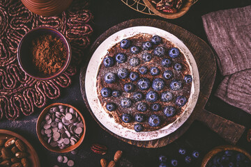 Homemade gluten free nut and chocolate cake with cream cheese and fresh blueberries
