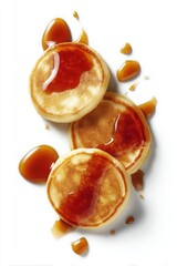 Stack of pancakes drizzled with syrup on white background overhead shot breakfast food photography