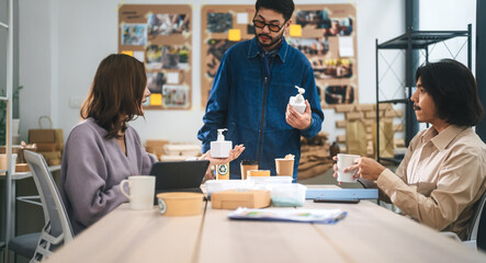 Asian business meeting man and woman in an ESG indoor office using recycle material for sustainable product save the planet