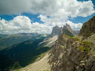 Spectacular view of Seceda ridgeline in the Dolomites, Italy. Dramatic limestone peaks rising above vibrant green slopes under a bright summer sky &mdash; a breathtaking natural masterpiece.