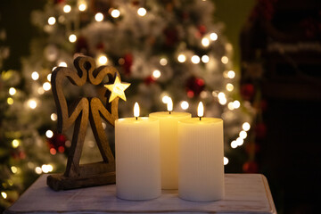 Christmas candles, blurred bokeh lights on the background.