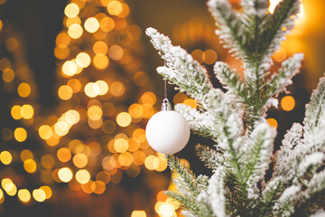 Close up of balls on christmas tree. Bokeh garlands in the background. New Year concept.