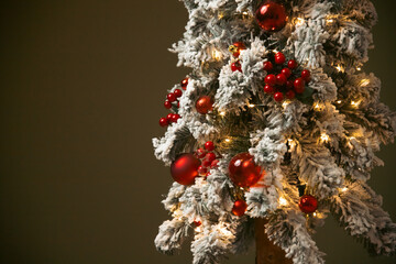 Christmas tree with snow and red balls and copy space.