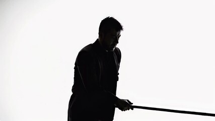 Dramatic silhouette of man gripping rope in distress. Camera pans from wide shot to intimate closeup, revealing emotional struggle and tension. Moody monochrome aesthetic for mental health content.
