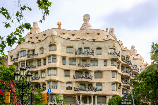 Barcelona, Spain - June 13, 2025: Casa Mila, also known as La Pedrera, showcases Antoni Gaudi&rsquo;s distinctive undulating stone facade and wrought-iron balconies in Barcelona, Spain. 