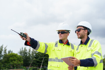Engineers inspecting land for new factory or construction project.