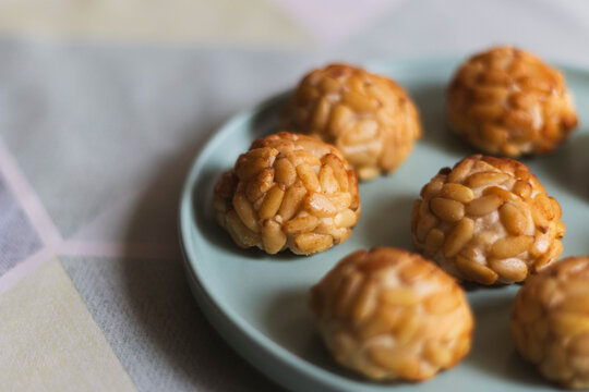Traditional Catalan pine nut sweets panellets on a pastel plate