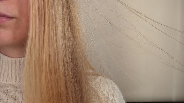 Macro view of blonde hair with static electricity near face in natural light. Perfect for beauty, haircare, dryness, shampoo, conditioner, and cosmetic advertising visuals.