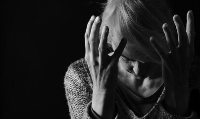 woman praying with hands together on grey black background with people stock image stock photo