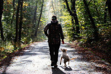 Woman and her dog in autumn landscape