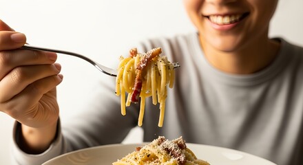 Young woman smiling while eating spaghetti for lunch at a restaurant