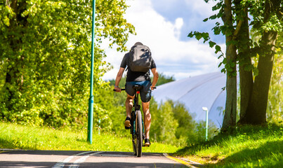 Cyclist ride on the bike path in the city Park
