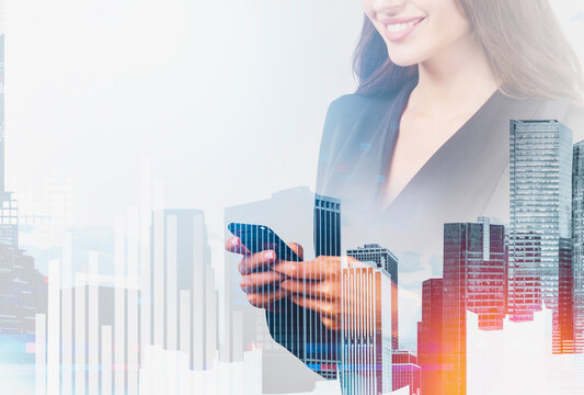 Smiling businesswoman using smartphone, double exposure style with tall modern city buildings and abstract bar charts, symbolizing digital business growth - Powered by Adobe