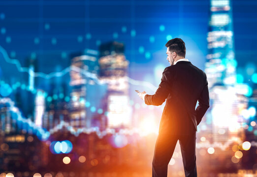 Businessman in suit using smartphone with illuminated city skyline, glowing financial graphs, and bokeh lights in background, concept of finance - Powered by Adobe