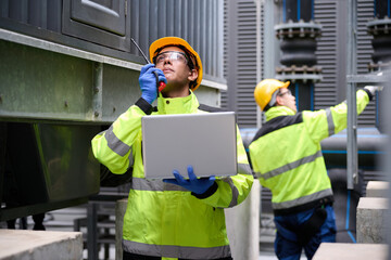 Engineers inspecting a power plant for maintenance and troubleshooting issues. They are using a...