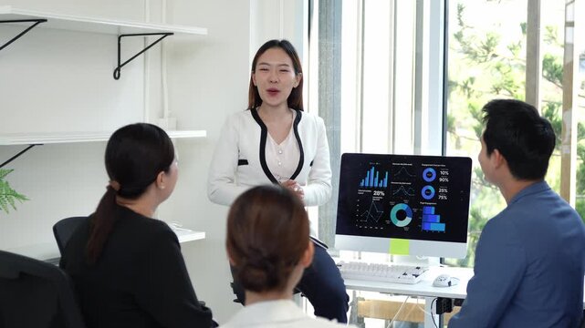 Professional business team celebrating successful project completion, exchanging congratulatory handshakes after compelling presentation in bright, modern corporate workspace