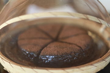 Delicious brown steamed cake, traditional dessert food in bamboo basket. hot, warm steam rising from sweet pastry creates very appetizing and comforting feeling