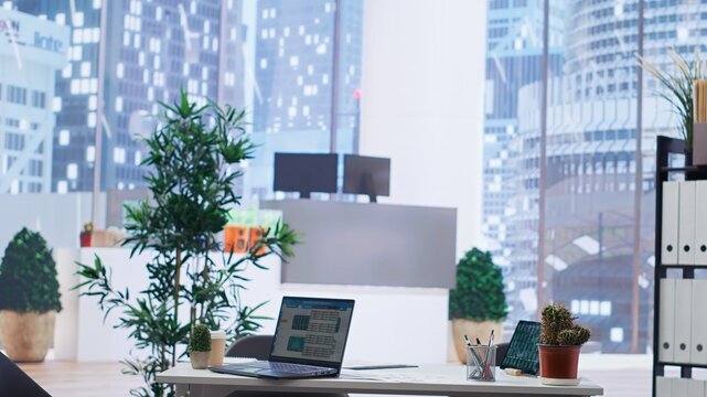 Laptop on desk in office showing stock exchange indices changing in real time. Notebook in workplace with forex trading indexes displayed live showing latest price modifications