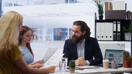 Financial adviser providing clients with informative leaflets on retirement planning, tax issues...