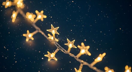 A string of warm golden star shaped lights glows against a dark starry night sky creating a magical and festive atmosphere perfect for holidays and celebrations