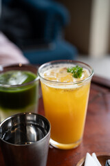 Refreshing orange drink with ice and garnish, vibrant colors and inviting atmosphere.