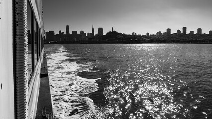 Black and White View of San Francisco Skyline from Ferry Boat with Sun Glare