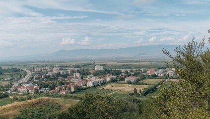 Obraz premium Distant Mountains, Vast Dry Hillside Landscape Overlooking Distant City and Plains at Dusk