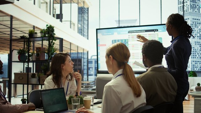 Accounting manager reviewing budget numbers after all monthly costs, working on a financial projection to deduct the future enterprise situation. Presenting infographics during a meeting. Camera B. - Powered by Adobe