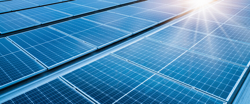 solar panels on rooftop at sunlight with bright sun flare,landscape of Solar cell panels in a photovoltaic power plant.concept of sustainable resources,green energy
