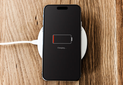 Smart phone Charging On Wooden Surface Mockup PSD