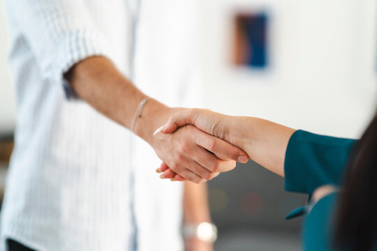 Two people shake hands, symbolizing agreement and partnership. This gesture signifies a successful negotiation or the beginning of a new collaboration.