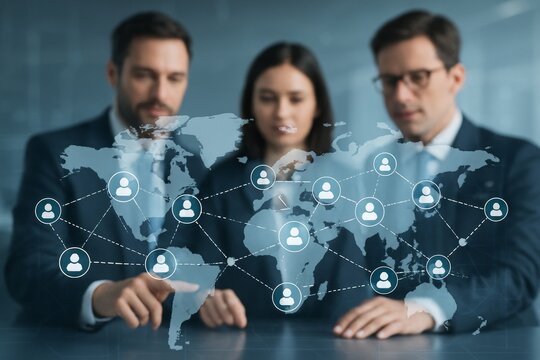 Business professionals analyzing global network connections with digital world map interface over a transparent screen in modern office environment.. Ai generative