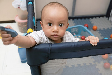 Cute little boy 11 months old playing on the mat with her toys, baby care, stock photo