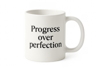 White mug showing progress over perfection quote
