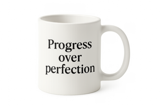 White mug showing progress over perfection quote
