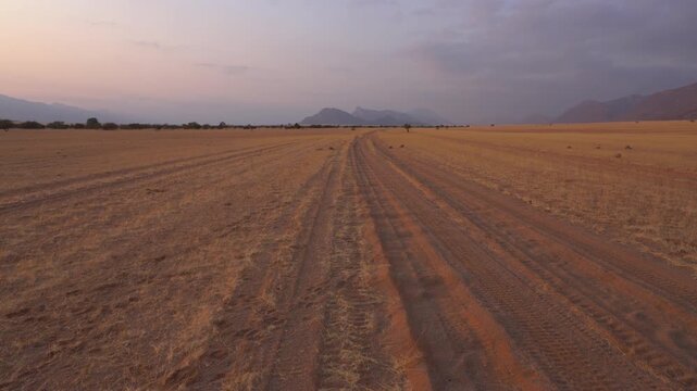 Sunrise on a sand road in Marienfluss valley in Kaokoveld in Namibia, Africa.