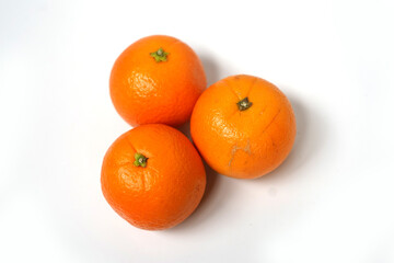 Group of Three Juicy Oranges on White Background.