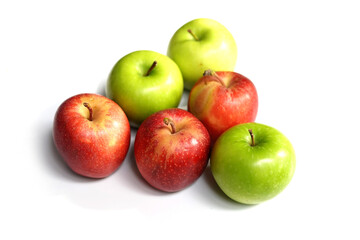 Fresh Red and Green Apple Fruits Forming Triangle on White Surface.
