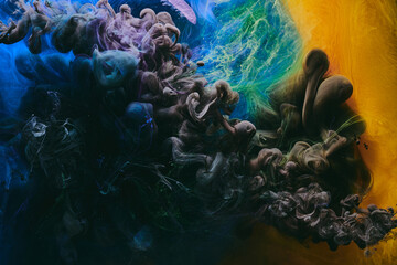 Abstract colorful smoke, dark background. Moving flow of yellow, blue, black paints, fluid art