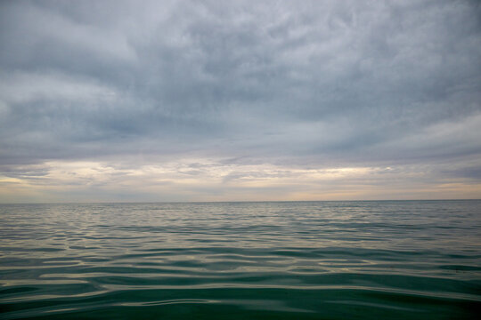 Still water beneath a brooding sky at dusk