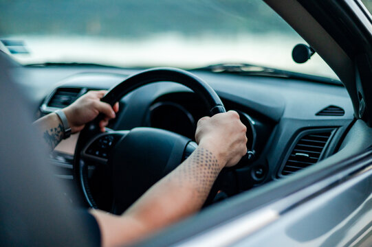 Person holds the steering wheel while driving