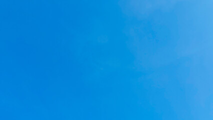 Clear Blue Sky Background with Soft Light Clouds
