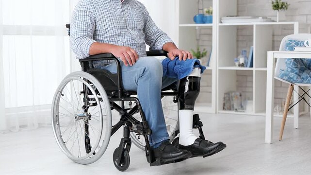 Disabled man with artificial leg sitting in wheelchair