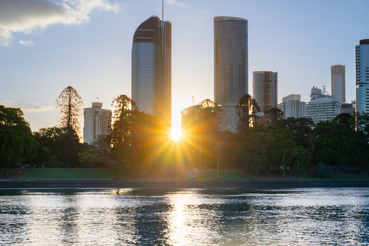 sunflare through tall buildings, from the Brisbane River  