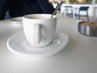 Hot coffee in the cup on old wood table with blur nature background.