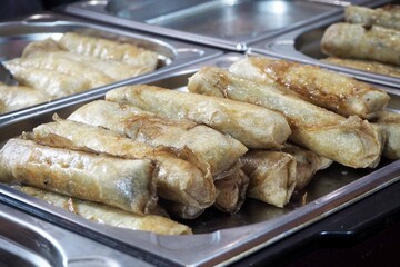 Fried spring rolls are in a metal container. Nem Ran. Vietnamese cuisine at the World Cuisine Festival.