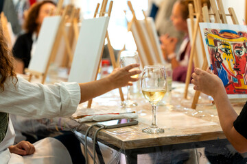 Art & Wine workshop. People painting and drinking wine at art workshop