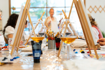 People enjoying wine and painting workshop activity